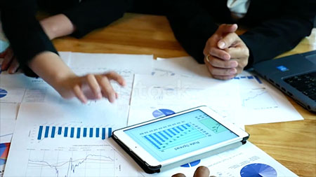 two-workers-looking-at-graphs