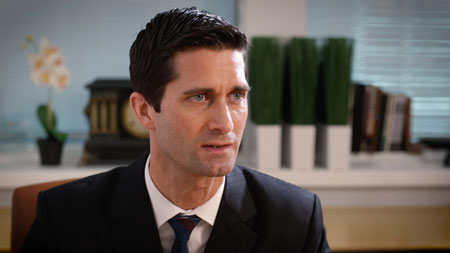 man-in-dark-suit-and-dark-tie-looking-off-camera-concerned