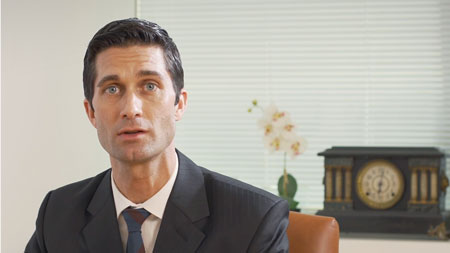 man-in-dark-suite-and-dark-tie-looking-at-camera
