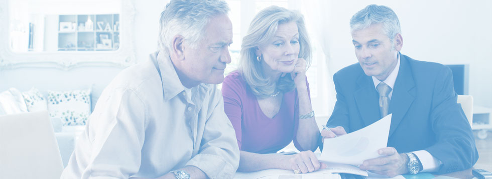 elderly-couple-looking-at-papers-with-advisor