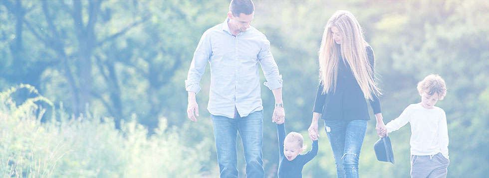 family-with-two-small-children-holding-hands-walking
