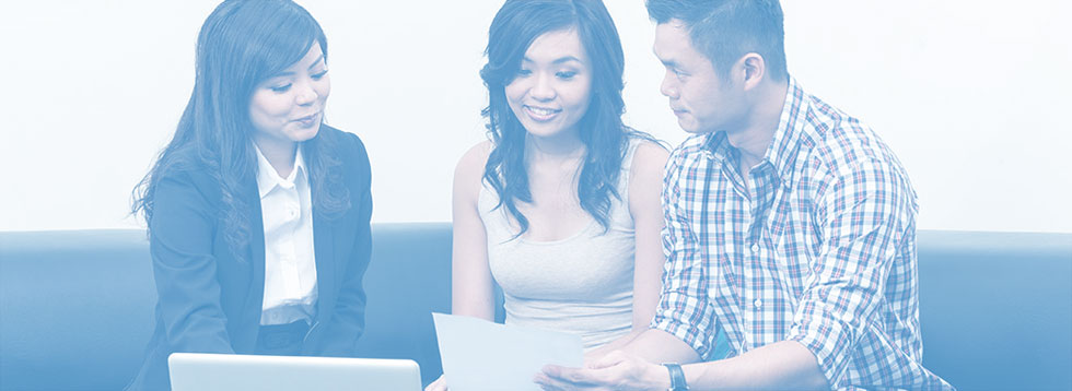 couple-looking-at-papers-with-advisor